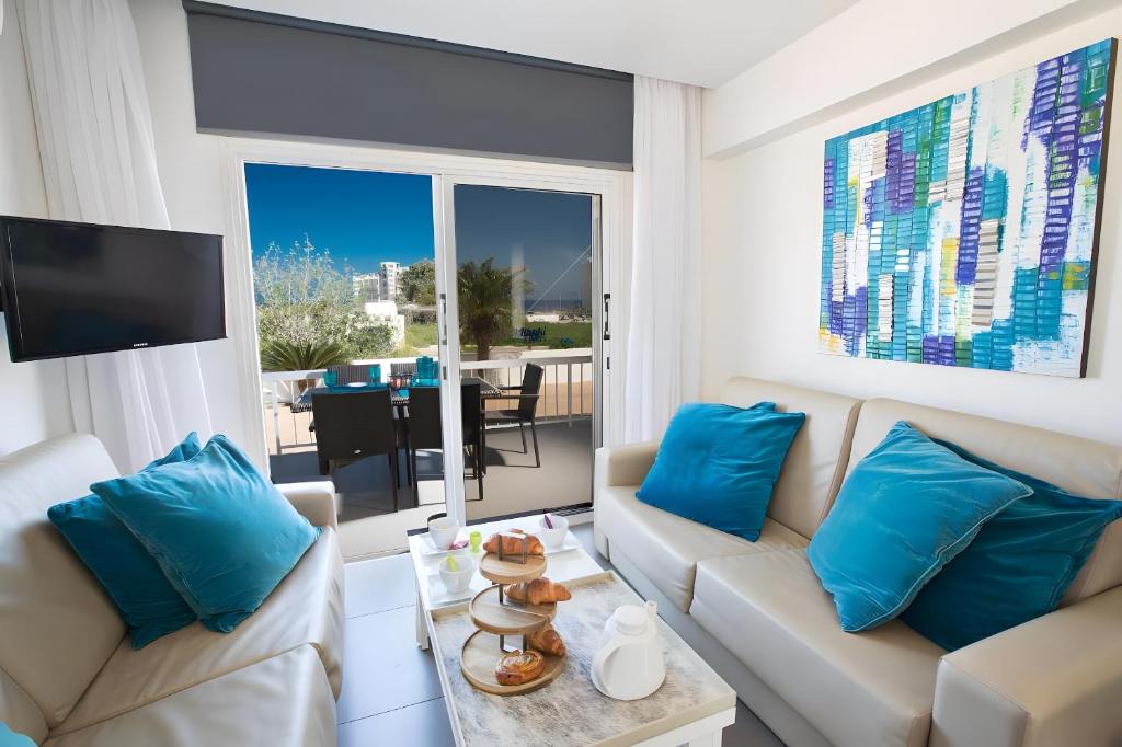 un soggiorno con 2 divani e una TV di Sun & Sea Seaview Apartment a Protaras