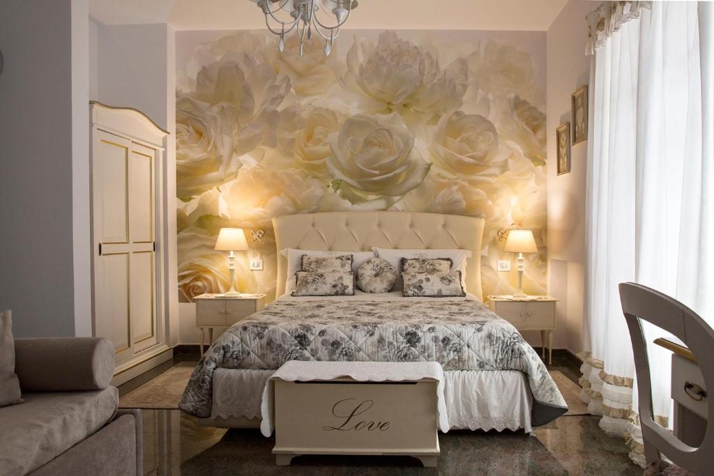 a bedroom with a bed and a flower mural at B&B Blanc Maison Etna Relais & Charme in Nicolosi