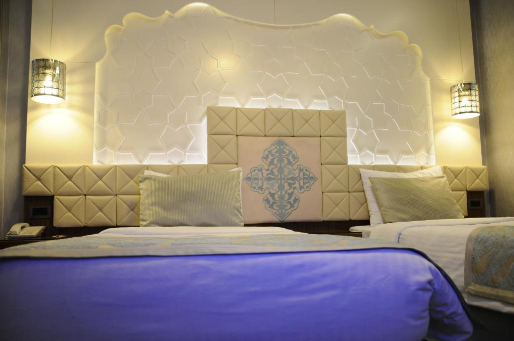 A bed or beds in a room at Grand Star Hotel Premium