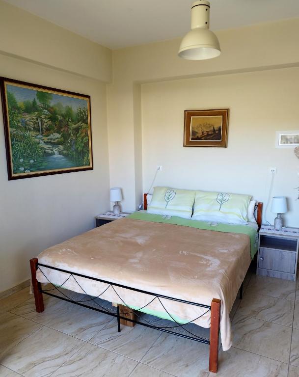 a bedroom with a large bed in a room at Mom's Cozy Corner in Heraklio