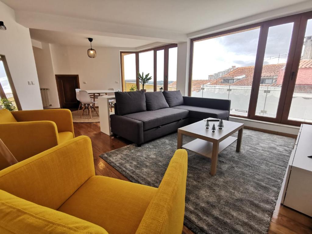 a living room with a couch and a table at Alta Guesthouse in Coimbra