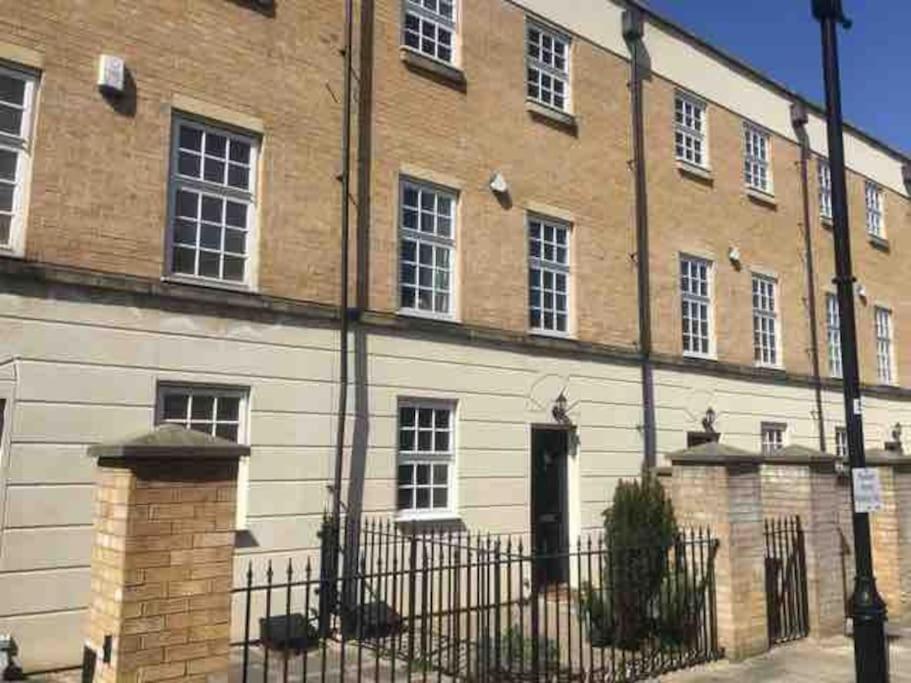 a large brick building with a black fence in front of it at Spacious Stylish House,R/way Museum,Parking,Garden in York