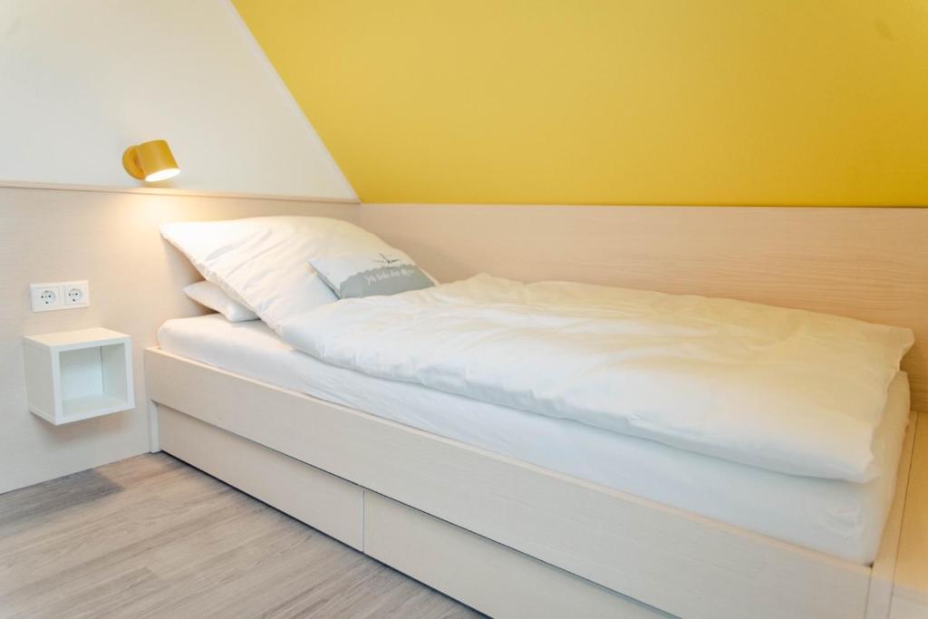 Postel nebo postele na pokoji v ubytování Küsten Apartments Tannenhausen