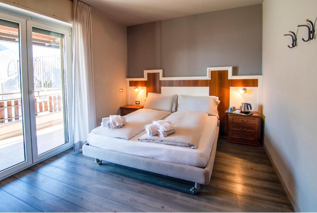 Postel nebo postele na pokoji v ubytování Hotel Saligari