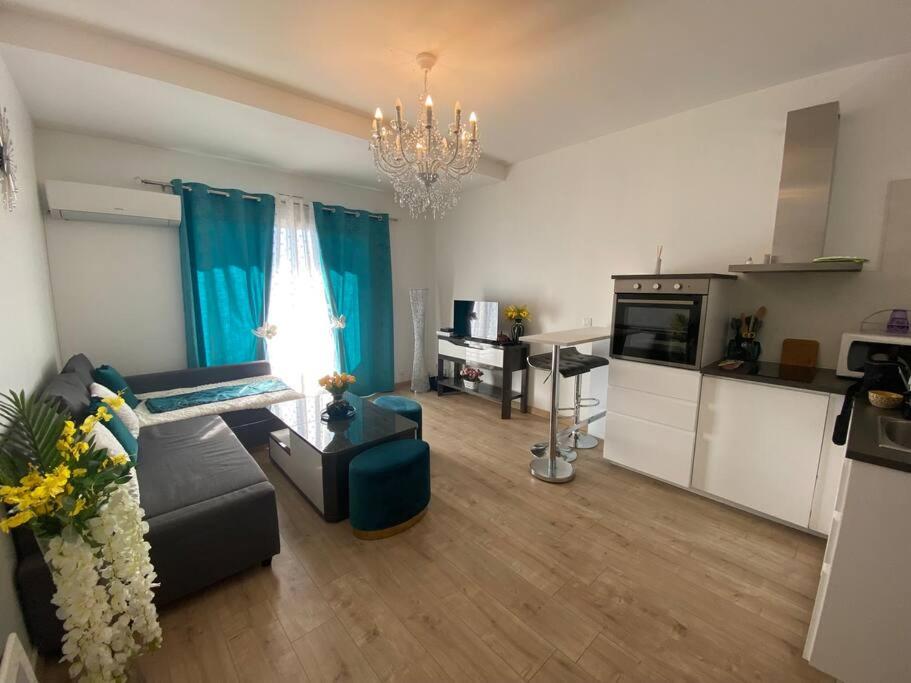 a living room with a couch and a kitchen at Studio vue Mer in Carry-le-Rouet