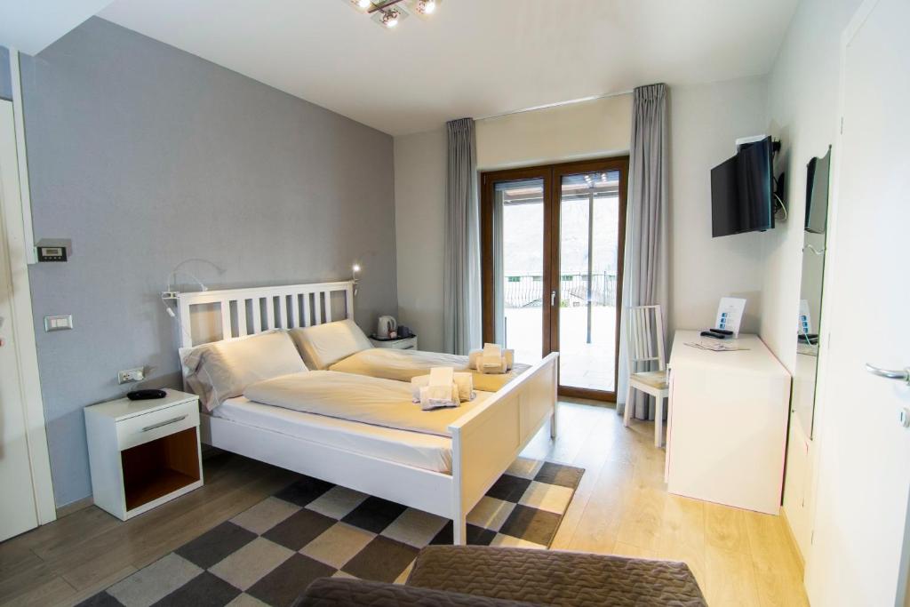 Postel nebo postele na pokoji v ubytování Hotel Saligari