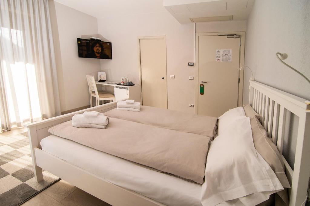 Postel nebo postele na pokoji v ubytování Hotel Saligari