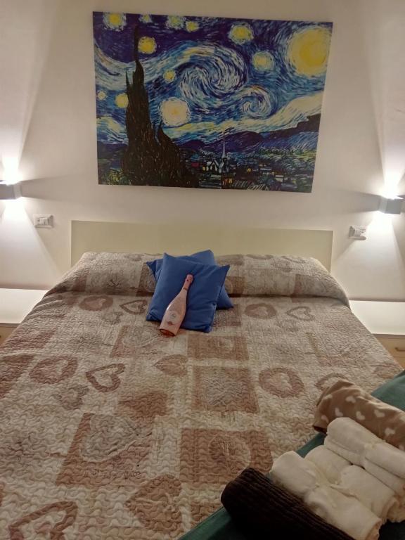 a bedroom with a bed with a painting on the wall at Da Anna e Michele in Andria