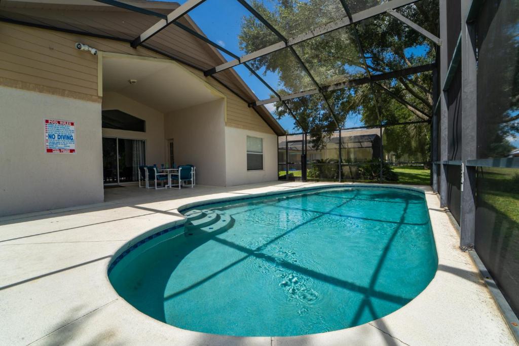 a swimming pool in the backyard of a house at 16150EGRET- Sun Chaser (S) in Orlando
