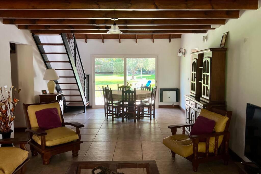 a large living room with a table and chairs at Casa en Ing. Maschwitz con gran parque y pileta in Ingeniero Maschwitz