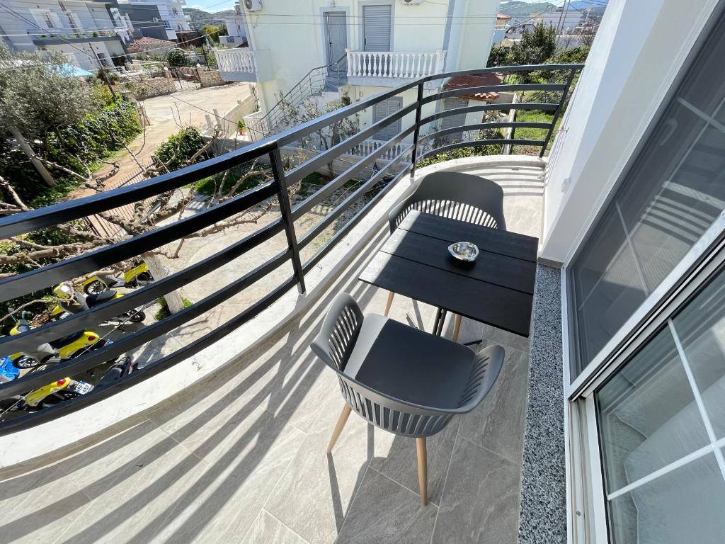 a balcony with two chairs and a table at Villa Denis Ksamil in Ksamil