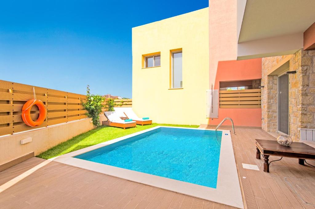 a swimming pool in the backyard of a house at Villa Petra Gouvia by Villa Plus in Gouvia