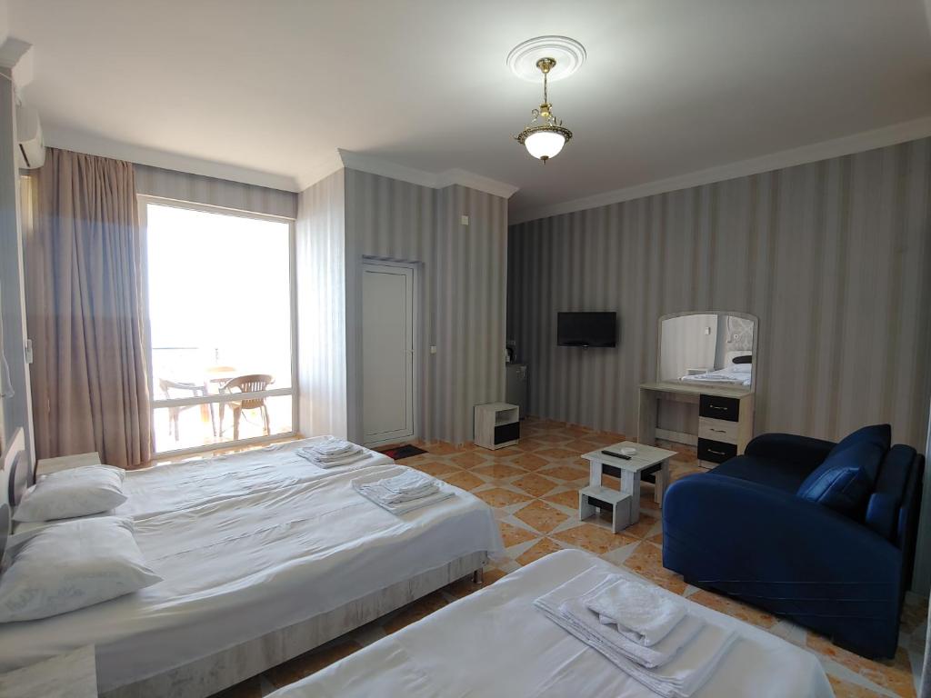 Postel nebo postele na pokoji v ubytování Hotel Kvariati Nugo