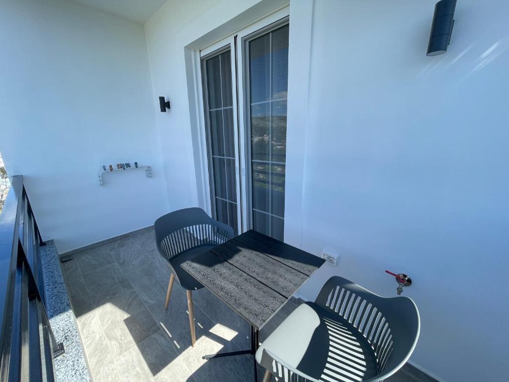 a balcony with two chairs and a table at Villa Denis Ksamil in Ksamil