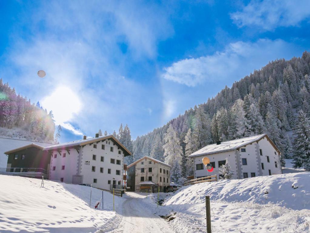 a group of buildings in the snow on a mountain at stettli resort in Parpan