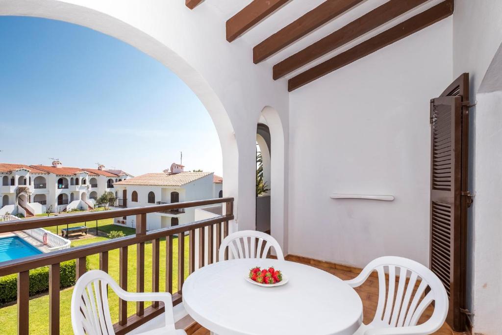 a white table and chairs on a balcony with a view at Girasols Gardens Sup in Son Bou