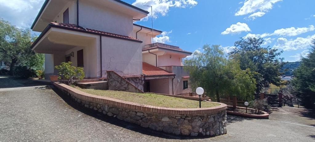 une maison avec un mur en pierre devant elle dans l'établissement Villa Acrocoro, à Montepaone