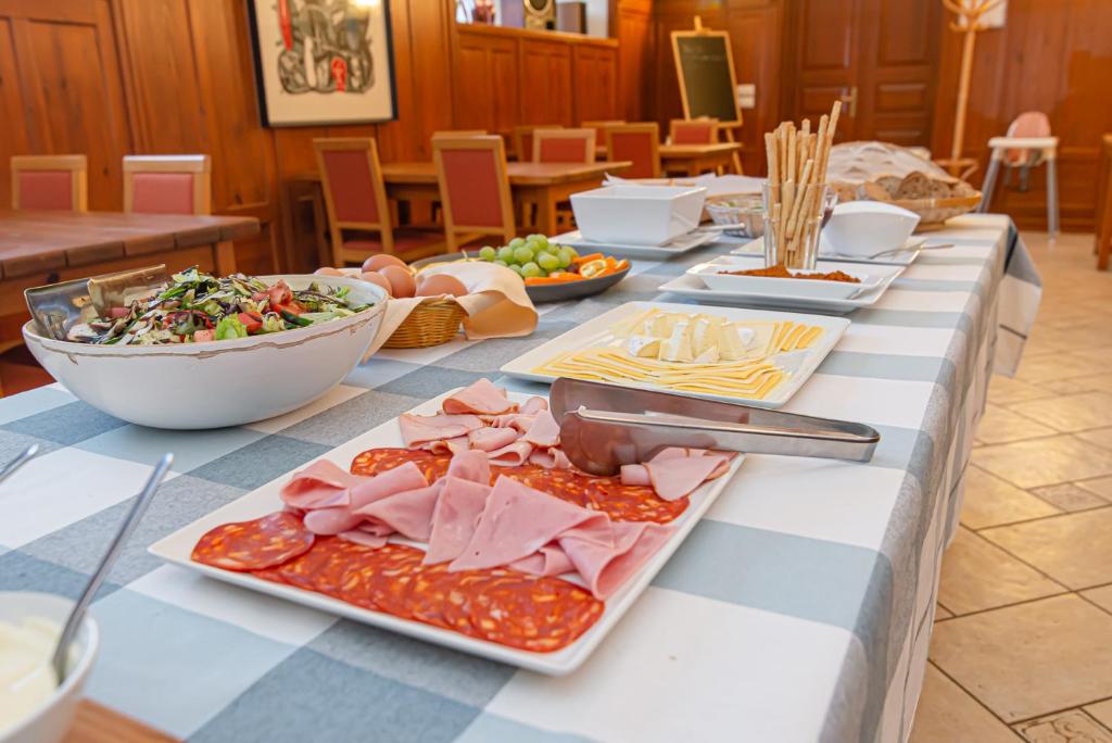 Domus Maria — A long table with plates of food on it