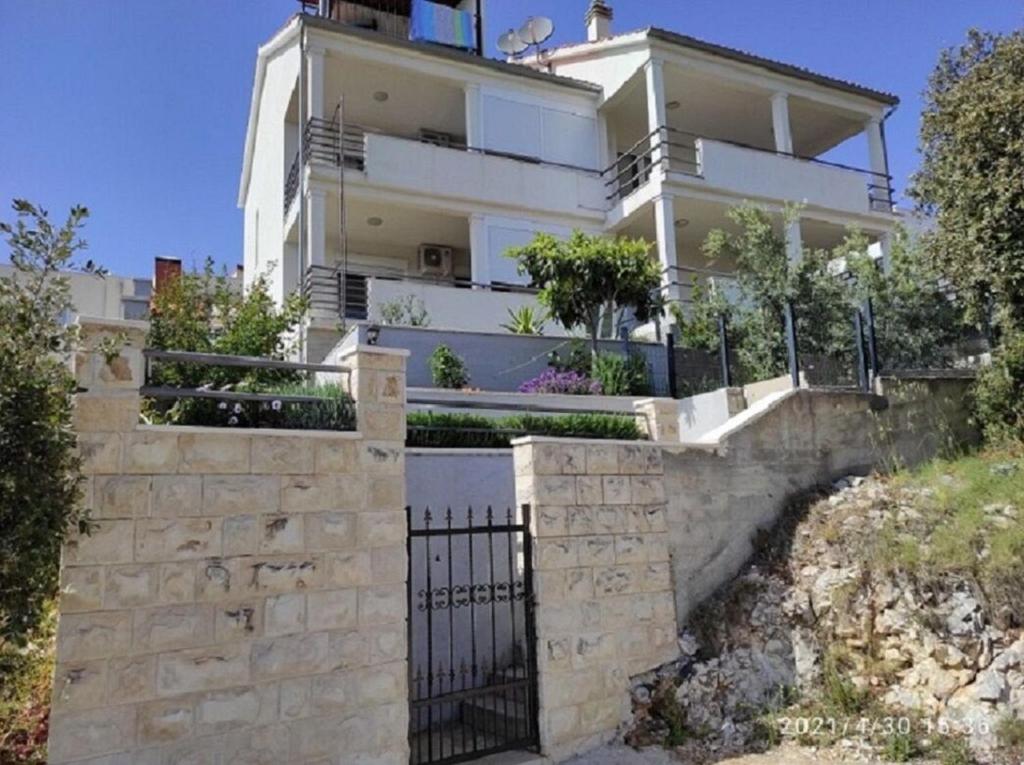 a house on a hill with a black gate at Apartments Matan in Sevid