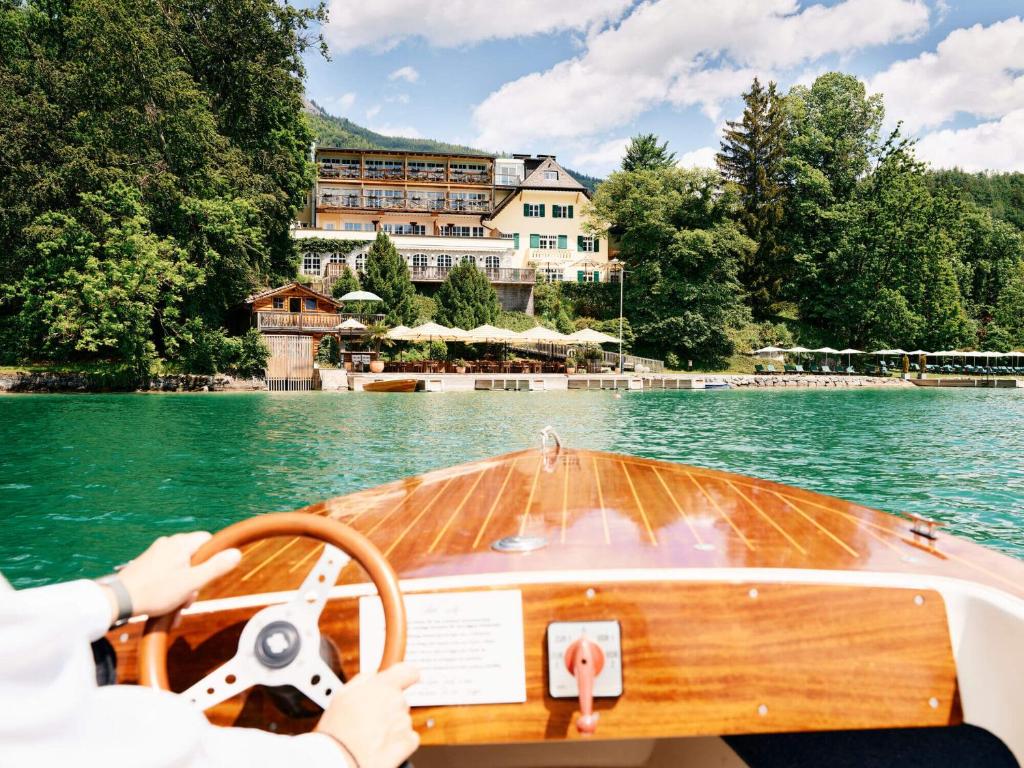 a person driving a boat in the water at Landhaus zu Appesbach in St. Wolfgang