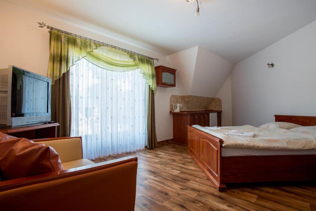 Posteľ alebo postele v izbe v ubytovaní Sykowny Dworek Apartamenty