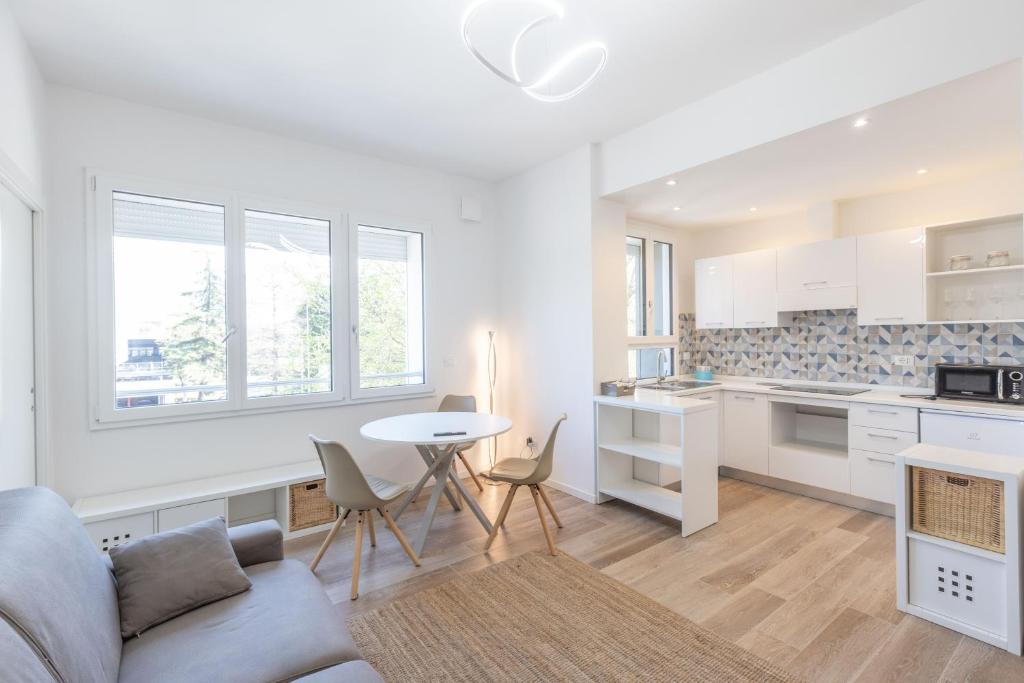 a kitchen and living room with a couch and a table at Malibò, Bologna By Short Holidays in Bologna
