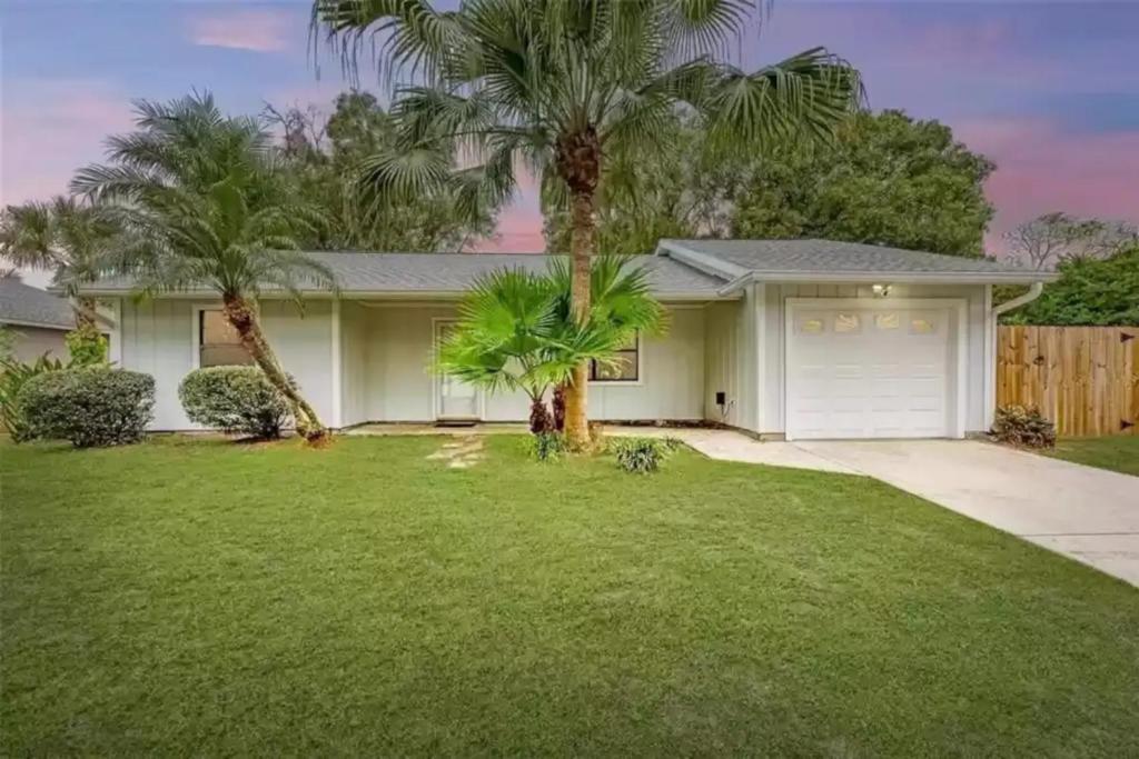 a house with palm trees in a yard at Venice Gardens, 2-Br Pet Friendly Home - Indra in Venice