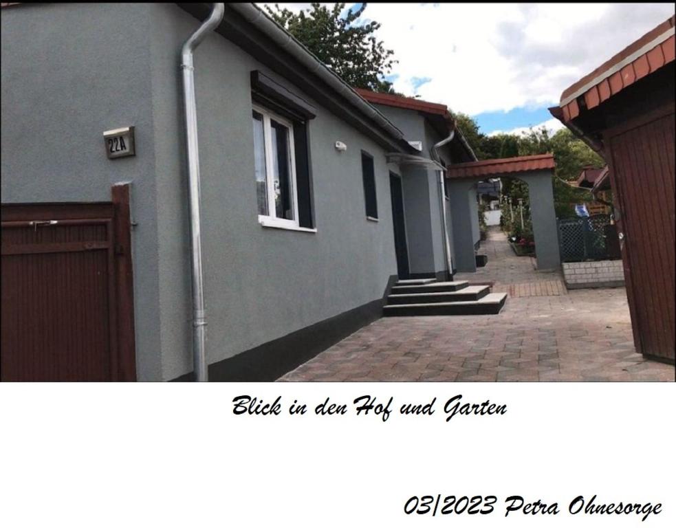 a house with a brick walk way next to a building at Ferienhaus im Harz in Harzgerode