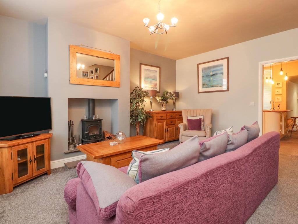 a living room with a couch and a tv at 21 West View in Clitheroe