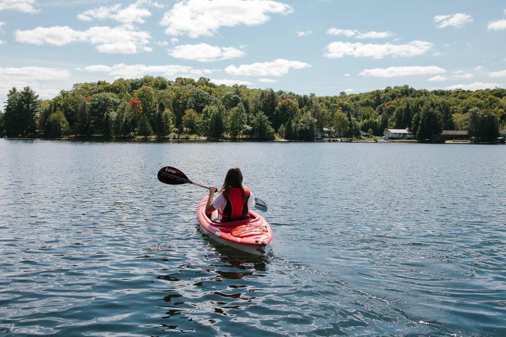 a woman in a kayak on a lake at Heather Lodge in Minden