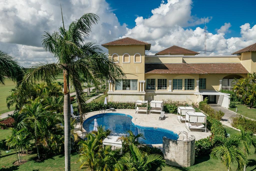 an aerial view of a house with a swimming pool and palm trees at Apartment Almas Iberosta Bavaro 3BDR with Pool and Private Beach in Punta Cana