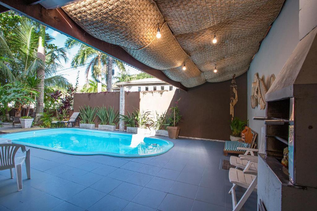 a patio with a swimming pool and a table and chairs at Pousada Castelinho in São Sebastião