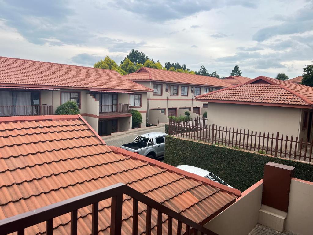 an aerial view of roofs of houses and a car at Just Bed & bath by mama R in Newcastle