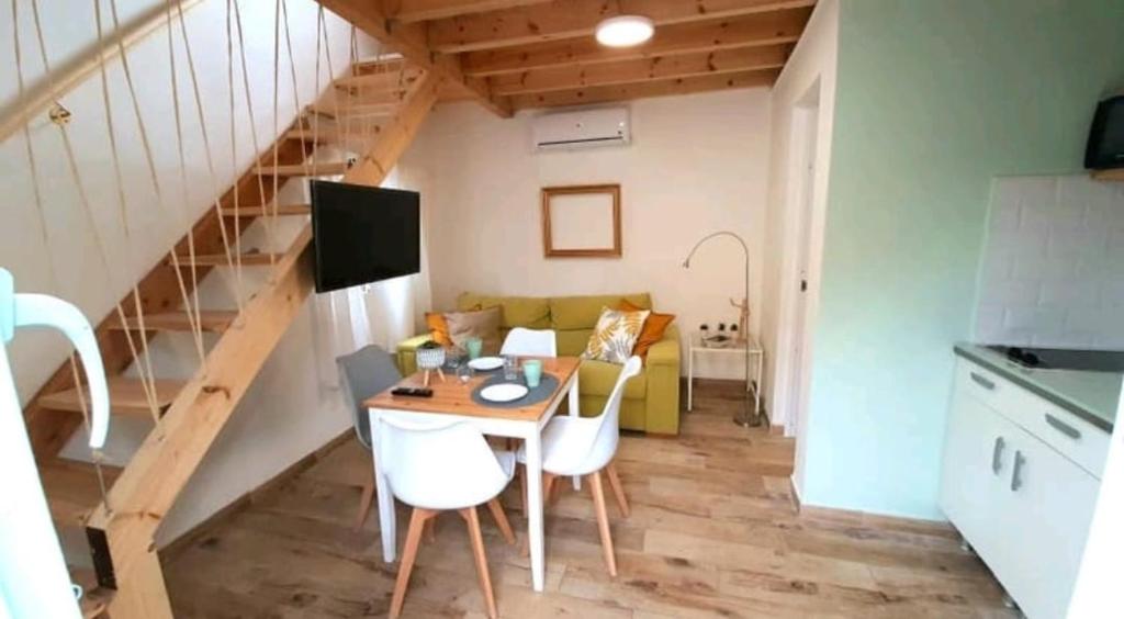 a small living room with a table and a couch at Casita de la playa in Rincón de la Victoria