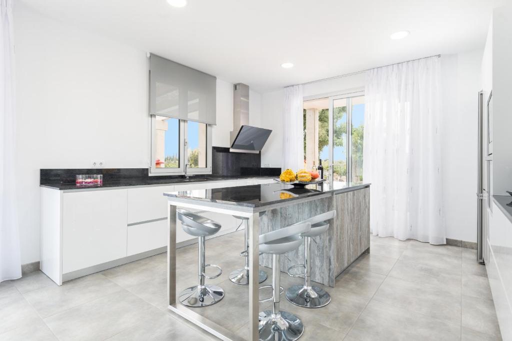 A kitchen or kitchenette at Villa Albaimar with swimming pool and garden
