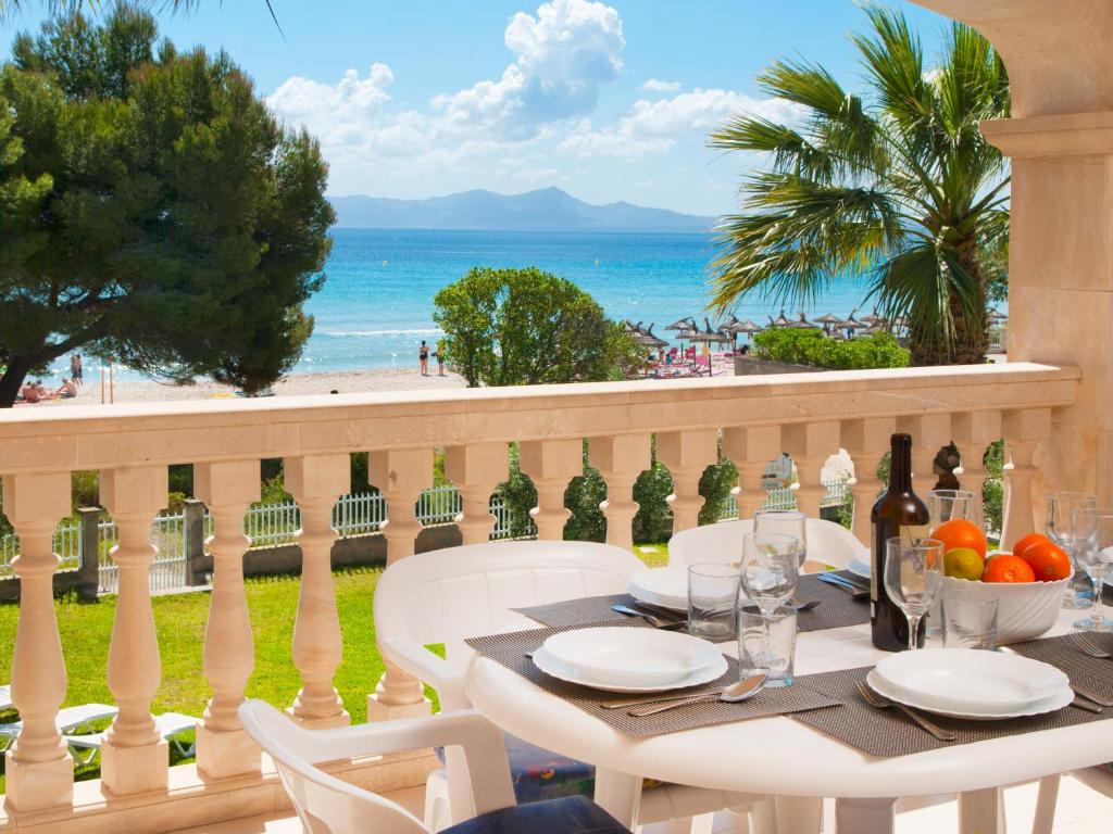 a table on a balcony with a view of the beach at Countess Attic E at Alcudia Beach in Alcudia