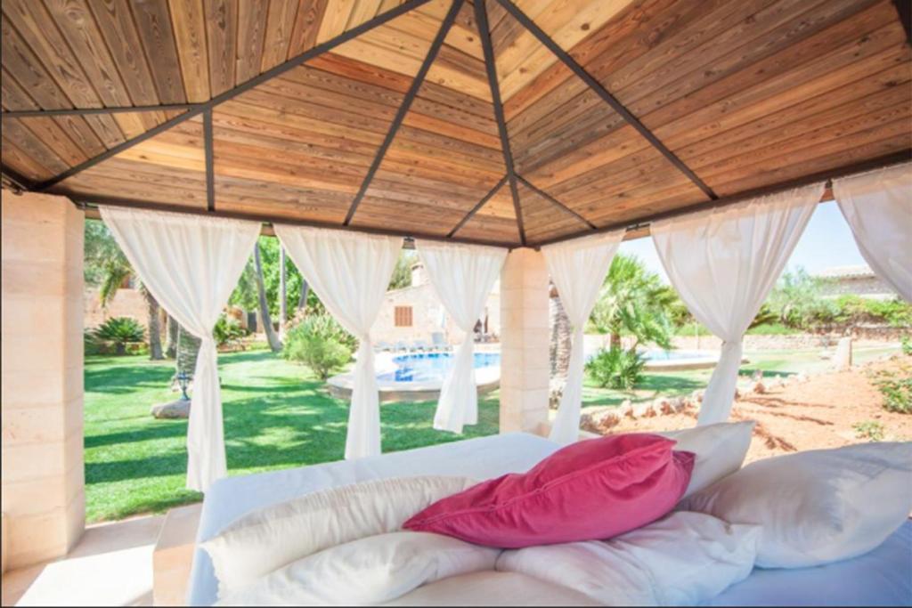 A bed or beds in a room at Can Rovey, pool and gardens in Inca