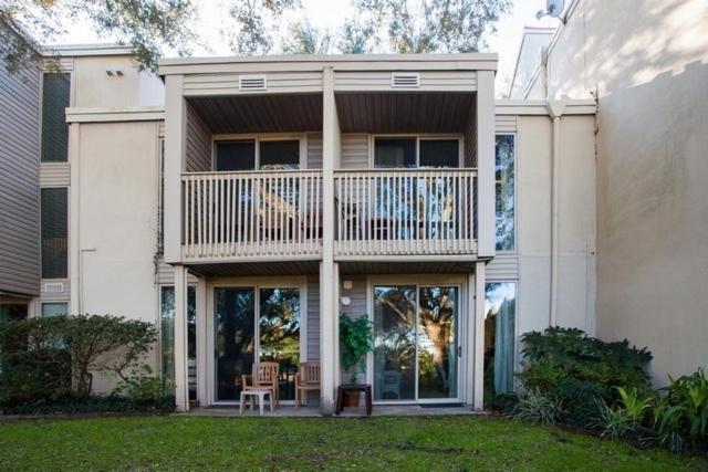 a large white house with a balcony on top of it at Villas by The Sea Two Bedroom Apartment in Jekyll Island