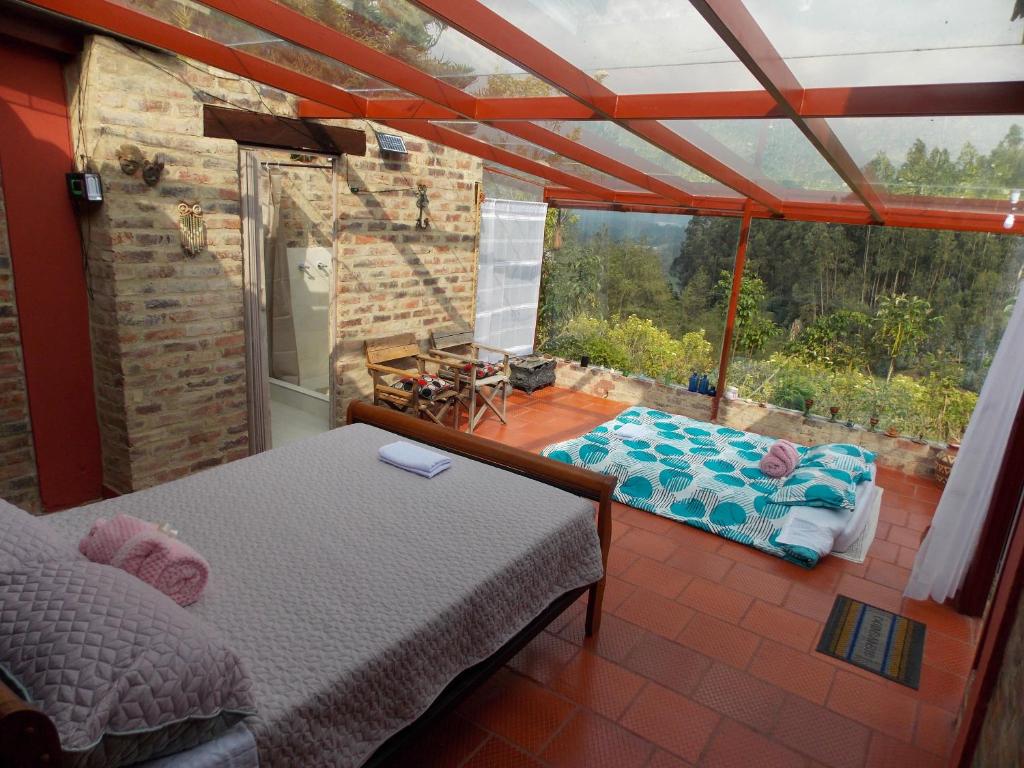 La IslaにあるPosada Turistica Los Josephのベッド1台、景色を望むバルコニーが備わる客室です。