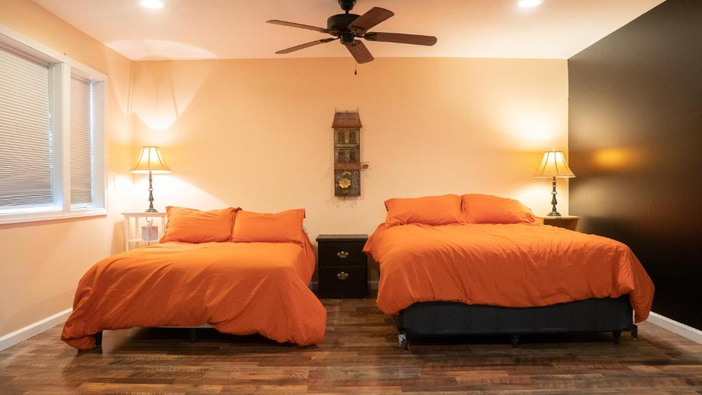 a bedroom with two beds and a ceiling fan at The Hive - An Elevated 420 Adventure in Cassopolis