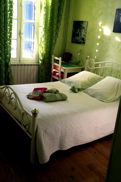 une chambre avec un lit avec des draps blancs et une fenêtre dans l'établissement DOMAINE DU SIESTOU WINE RESORT & spa, à Laure-Minervois