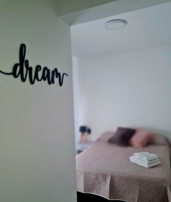 a bedroom with a bed with the word dream written on the wall at Work & Relax en Mendoza Chill in Mendoza