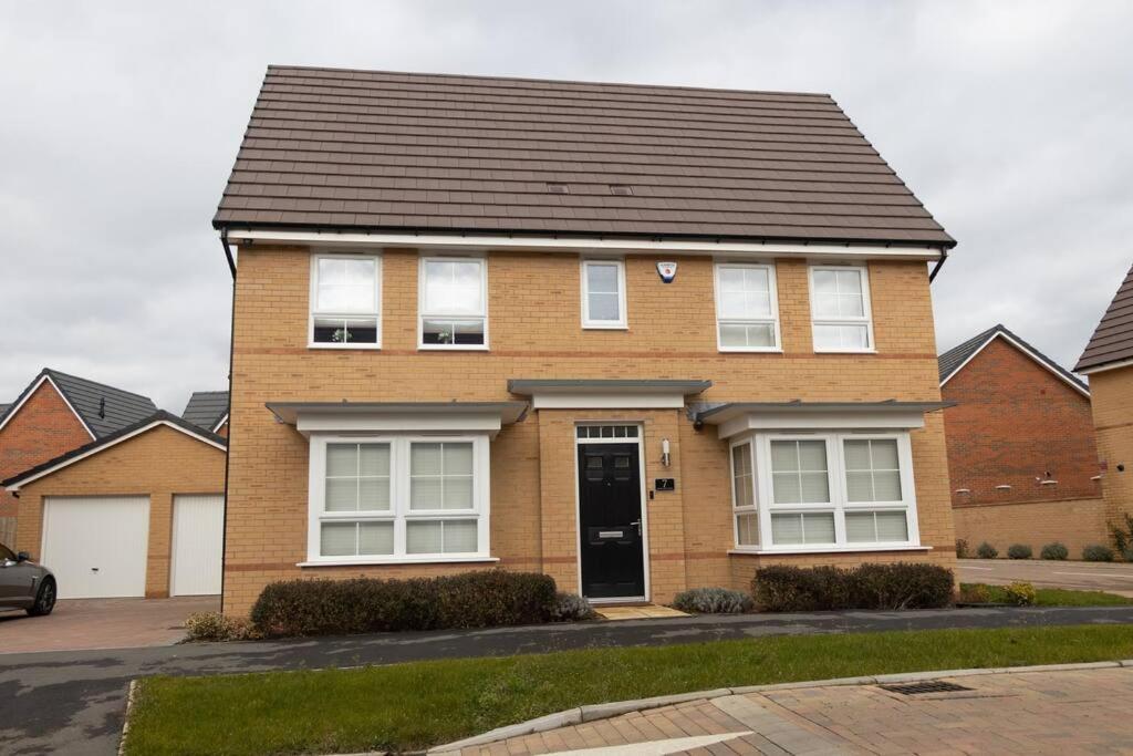 a brown brick house with a black roof at 7 Swiftsure - 4 Bedroom Luxury and Spacious Home in Milton Keynes