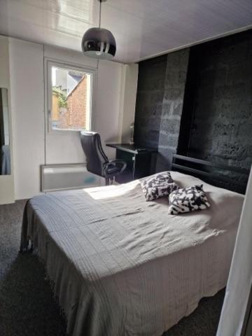 une chambre avec un lit avec deux oreillers dessus dans l'établissement LES CERISIERS 2, à Nogaro