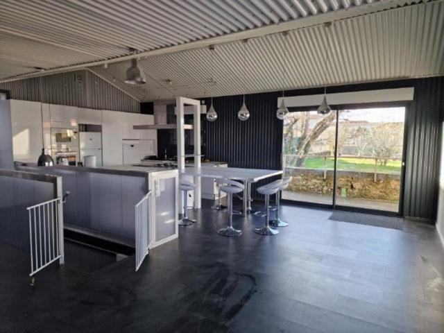 a large kitchen with a table and chairs in it at LES CERISIERS 2 in Nogaro
