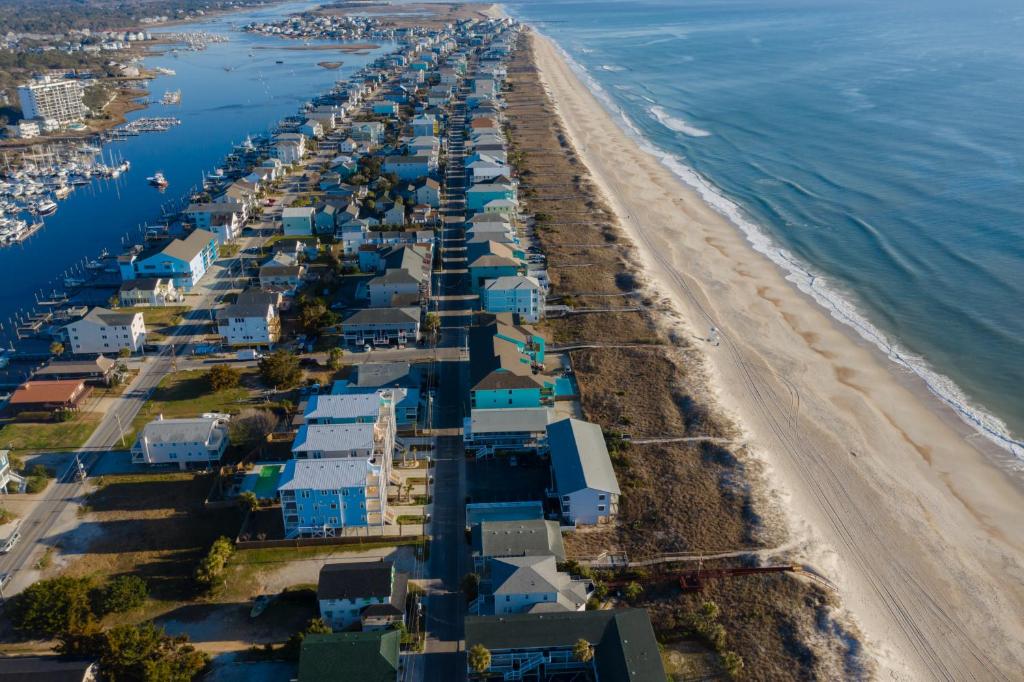 an aerial view of a beach with houses at The Beach House in Carolina Beach