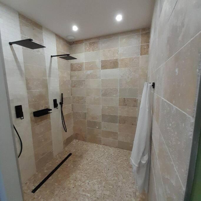 a bathroom with a shower with a shower curtain at instant à deux in Précigné