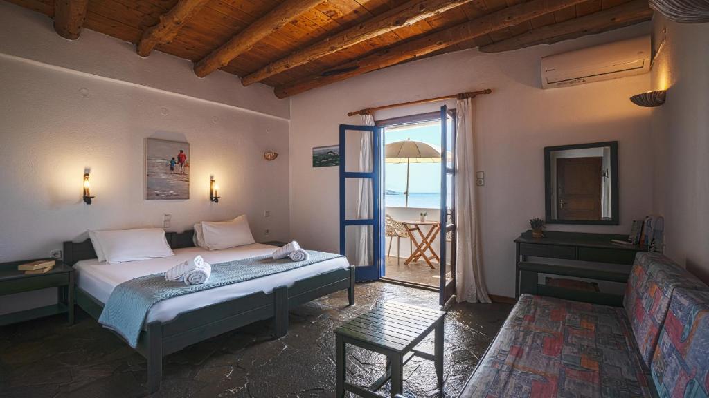 a bedroom with a bed and a view of the ocean at Villa Niki in Loutro