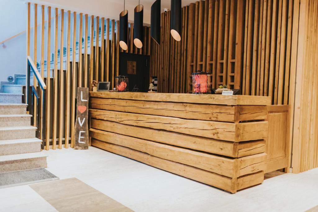 a lobby with a wooden counter and stairs at Pensiunea Antia in Durău