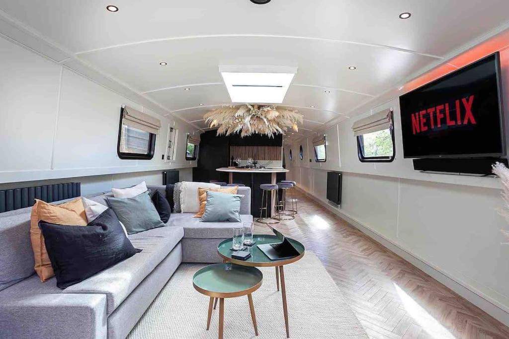 a living room with a couch and a tv at The Vätten Hüs A Luxury/VIP boat in Manchester